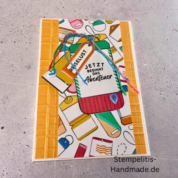 Handgemachte Karte mit Reise,Karte Reiselust mit Reise-Tags und Schleife, Karte Reiselust auf buntem Papier mit Weltmotiv, Layout der handgemachten Karte Reiselust mit Tags, Ansicht handgemachte Reiselust-Karte für Abenteuer, Geschenkidee Reisegruß handgemachte Karte Reiselust