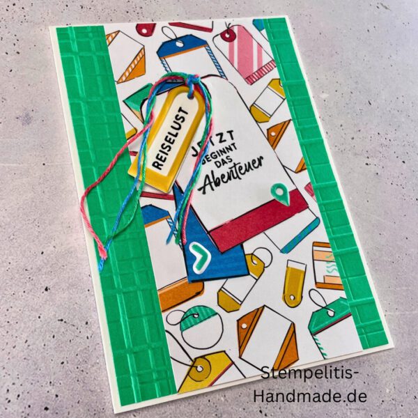 Handgemachte Karte mit Reise,Karte Reiselust mit Reise-Tags und Schleife, Karte Reiselust auf buntem Papier mit Weltmotiv, Layout der handgemachten Karte Reiselust mit Tags, Ansicht handgemachte Reiselust-Karte für Abenteuer, Geschenkidee Reisegruß handgemachte Karte Reiselust