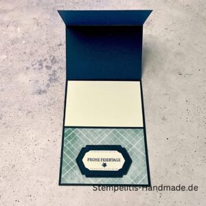 Aufstellkarte Frohe Feiertage handgemacht, Weihnachtskarte mit ausgestanzter Taube, dekorative Aufstellkarte hellblau und dunkelblau, Weihnachtsgrußkarte mit floralem Motiv, Detailaufnahme handgefertigte Weihnachtskarte, festliche Karte zum Aufstellen, elegante Frohe Feiertage Grußkarte