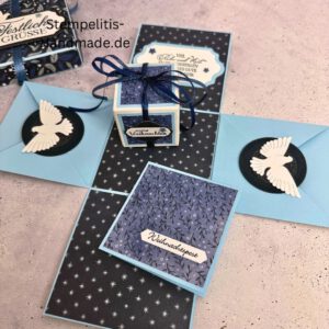Explosionsbox in Blau mit weißer Taube, Geöffnete Explosionsbox von oben mit Geschenk und Sternenmuster, Nahaufnahme vom Deckel mit Schriftzug Festliche Grüße, Detailansicht Taube auf blauem Hintergrund, Nahaufnahme der Box innen mit Etikett, Geschenkbox im Weihnachtsdesign mit Schleife, Handgemachte Explosionsbox im festlichen Look
